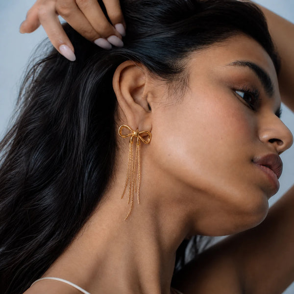 Aurielle Bow Drop Earrings worn by a model, side profile – sweatproof, hypoallergenic drop earrings
