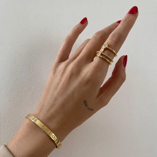 Crystal Screw Bangle worn on the wrist with gold rings, 18K gold PVD