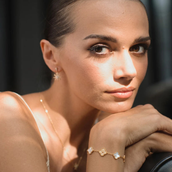 Five Clover Bracelet worn by a model, arm across the chest – sweatproof, hypoallergenic clover bracelet