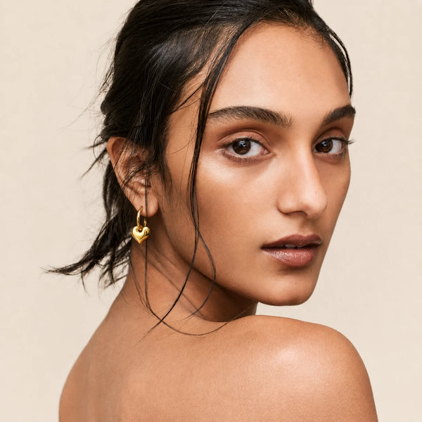 Gold Heart Hoop Earrings worn by a smiling model, waterproof gold hoop earrings
