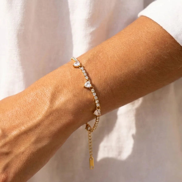 Heart Tennis Bracelet worn on the wrist with a white shirt, close-up – sweatproof, hypoallergenic tennis bracelet