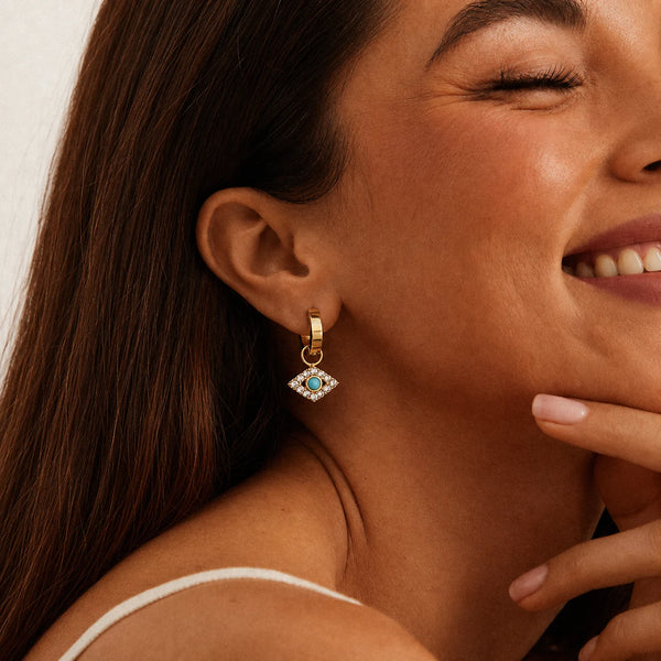 Nazar Charm Hoops worn by a smiling model – sweatproof, hypoallergenic evil eye earrings