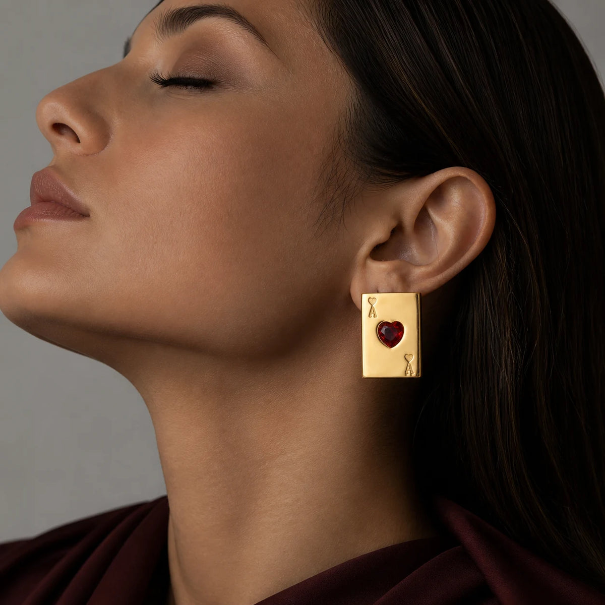 Ace of Hearts Earrings worn by a model in profile, eyes closed – stud earrings you can wear in the shower