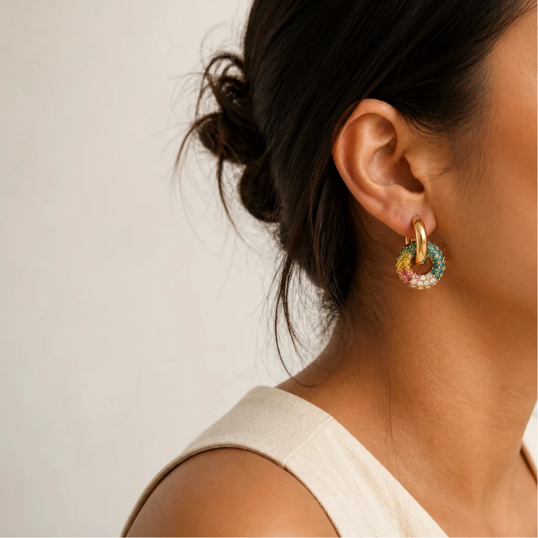 Aurora Prism Huggies worn by a model with hair in a bun, waterproof gold huggie earrings
