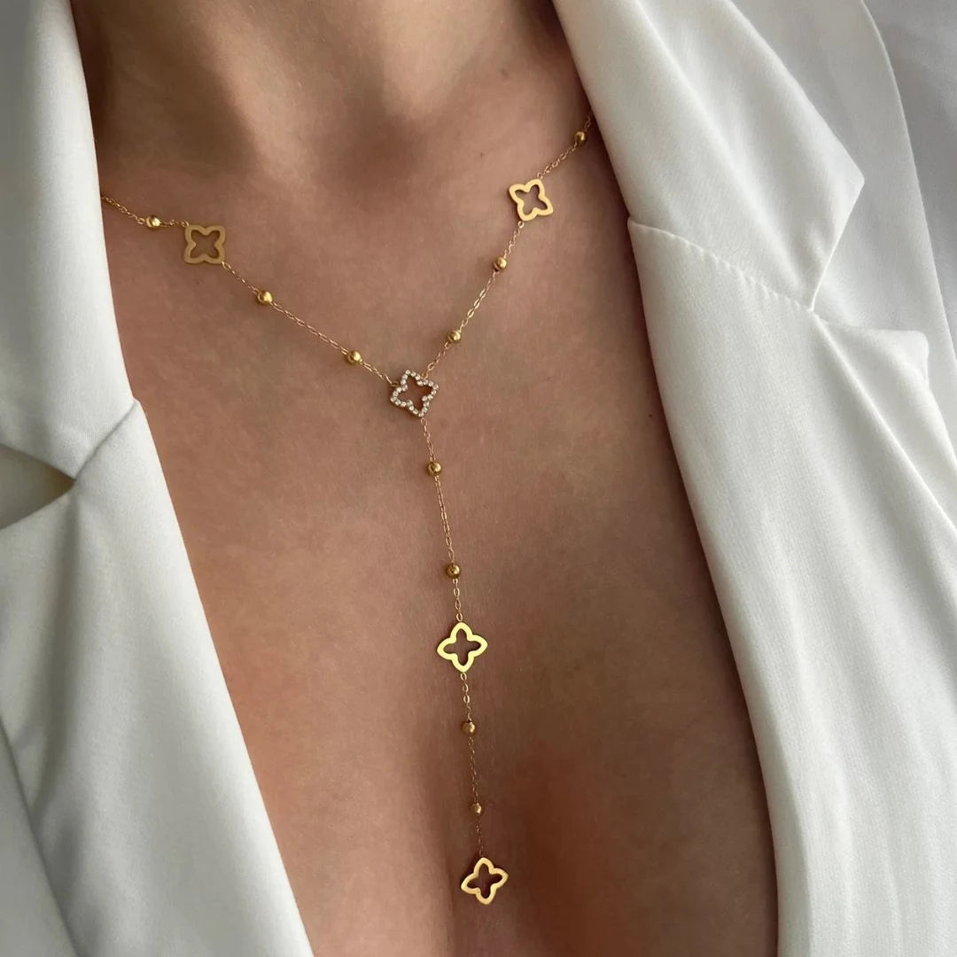 Clover Lariat Necklace worn with an open white shirt, 18K gold PVD