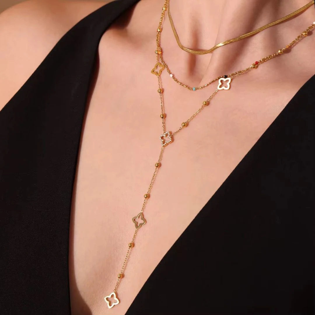 Clover Lariat Necklace worn with a black top, close-up