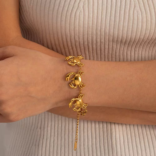 Crab Charm Bracelet worn on the wrist with a beige top – sweatproof, hypoallergenic charm bracelet