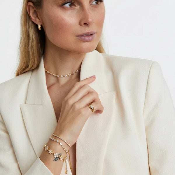 Crystal Flower Bracelet worn by a model in a white blazer – sweatproof, hypoallergenic flower bracelet