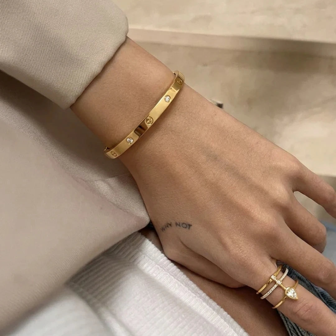 Crystal Screw Bangle worn on the wrist with a beige sleeve – sweatproof, hypoallergenic bangle