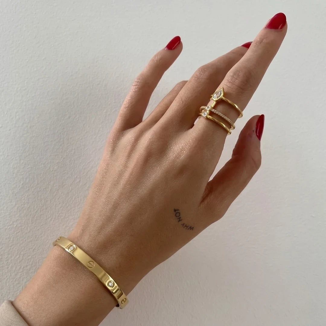 Crystal Screw Bangle worn on the wrist with gold rings, 18K gold PVD