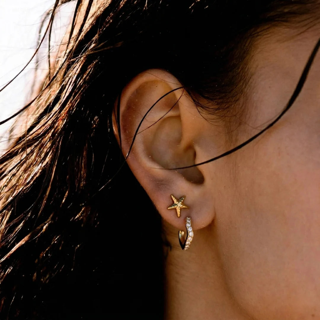 Elara Pavé Hoops worn by a model with wet-look hair