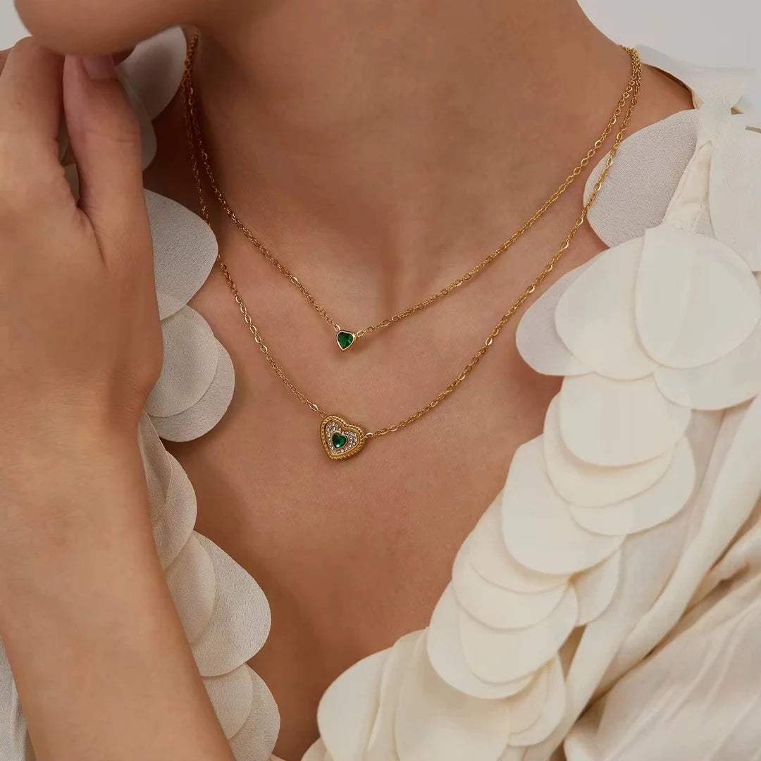 Emerald Heart Layered Necklace worn with a ruffled white blouse, waterproof gold layered necklace