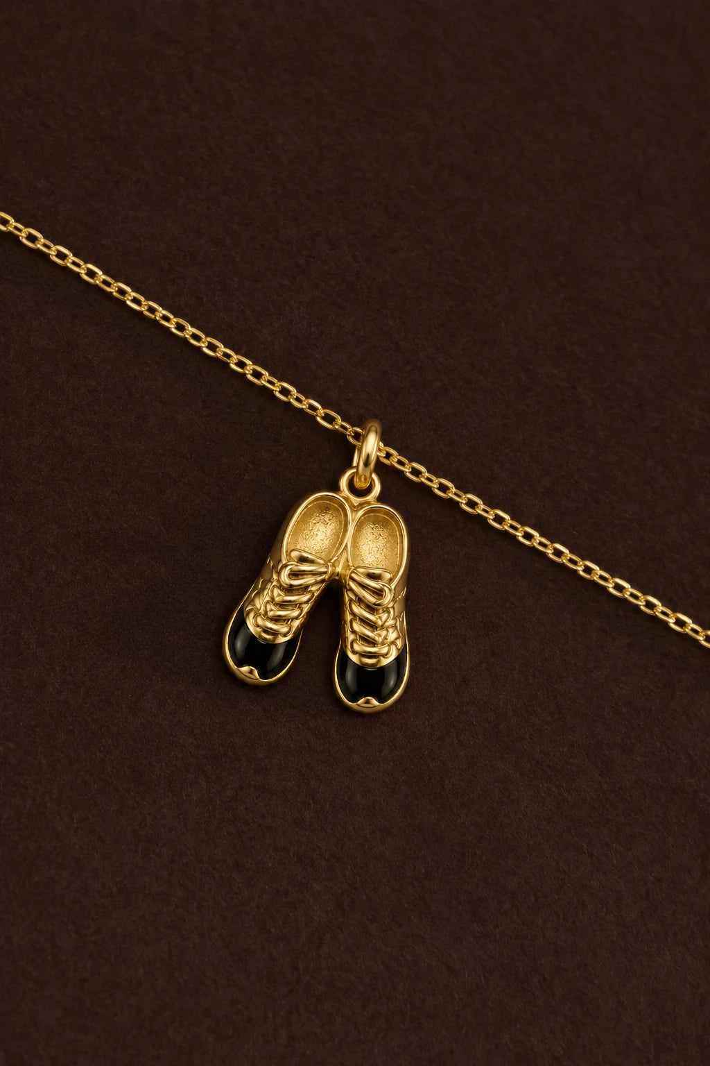 Football Cleats Charm on a gold chain against dark brown – anti-tarnish charm for daily wear