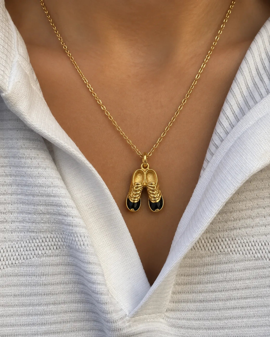 Football Cleats Charm worn on a gold chain with an open white shirt, waterproof gold charm