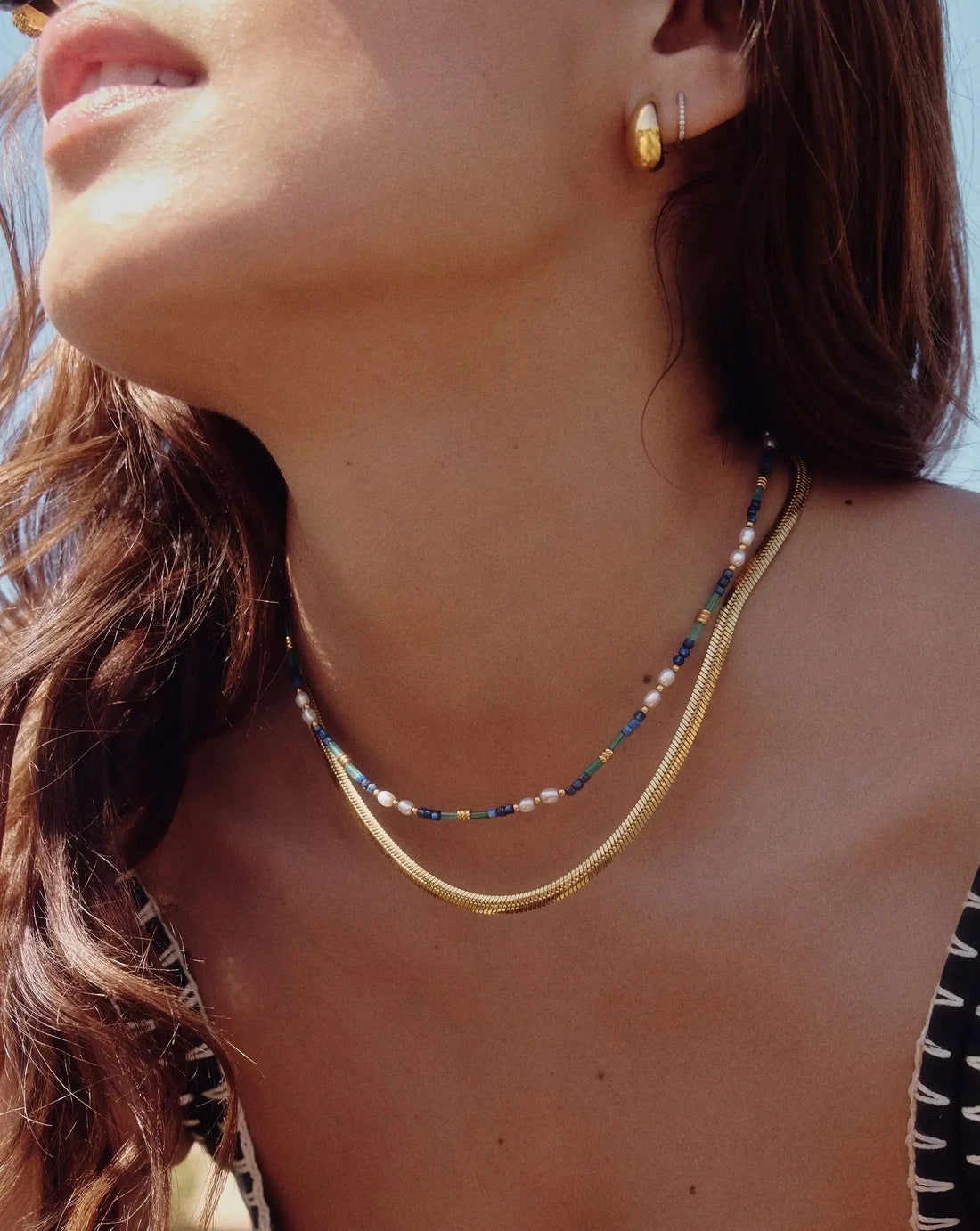 Golden Herringbone Necklace worn by a model with gold earrings – waterproof herringbone necklace for women in anti-tarnish 18K gold PVD | Priskel Jewellery