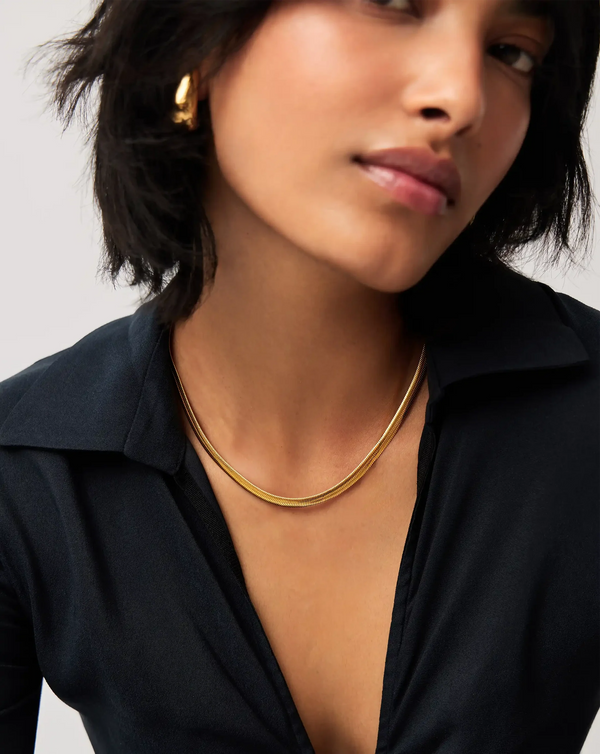 Golden Herringbone Necklace worn by a model in a black top – anti-tarnish herringbone necklace for daily wear