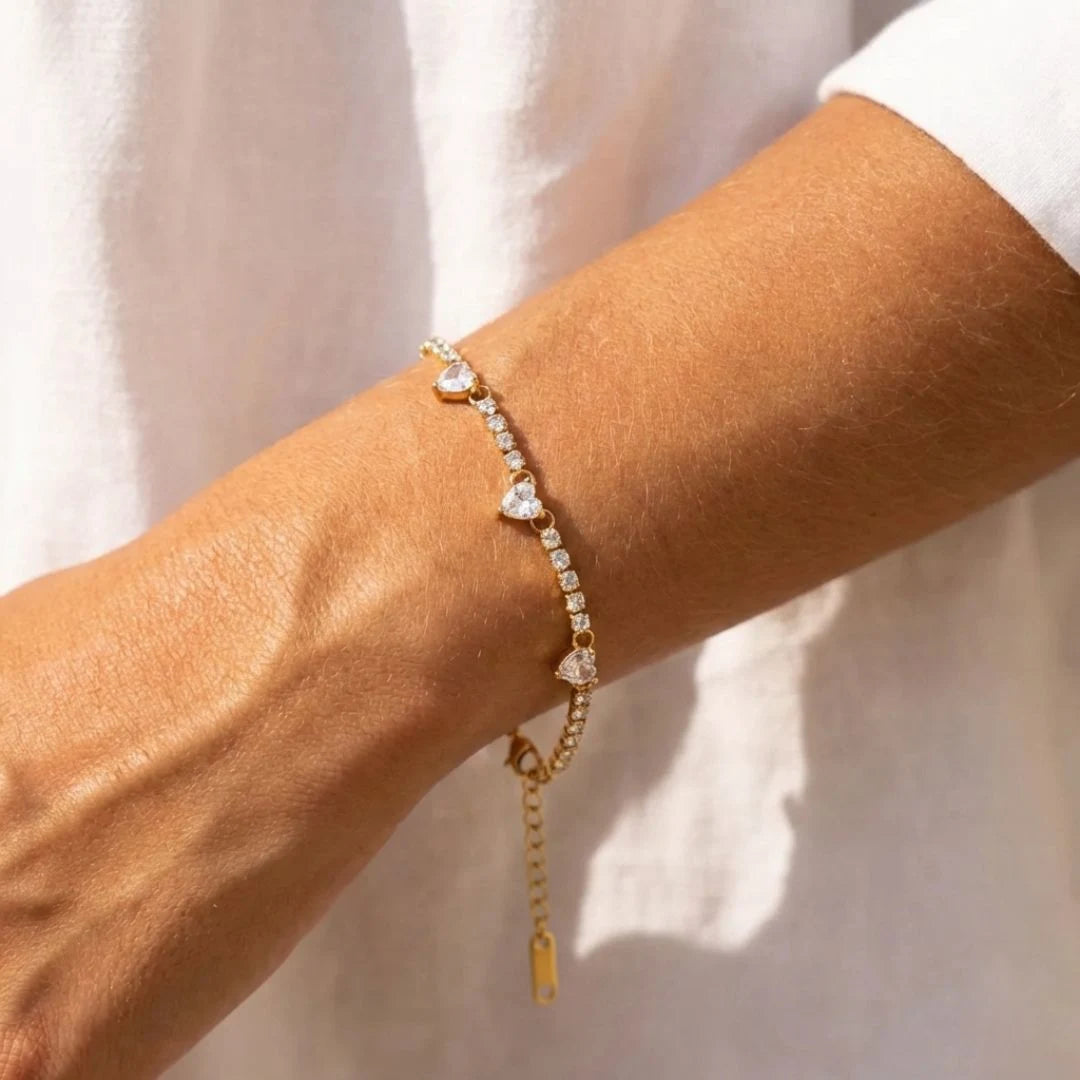 Heart Tennis Bracelet worn on the wrist with a white shirt, close-up – sweatproof, hypoallergenic tennis bracelet