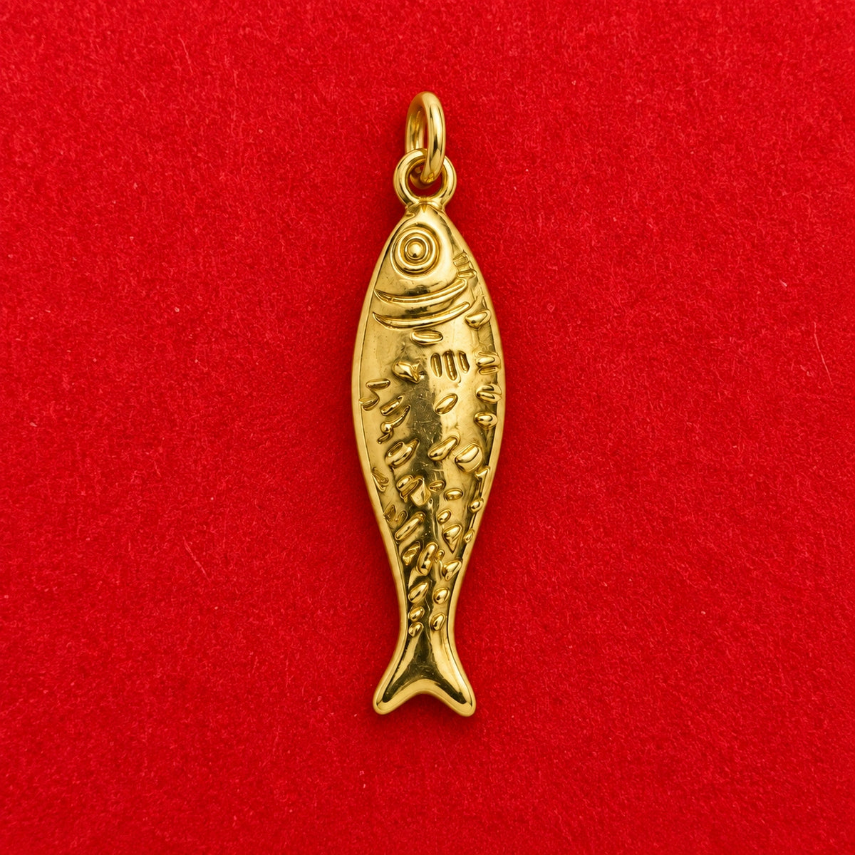 Lucky Fish Charm on a red background – anti-tarnish charm for daily wear