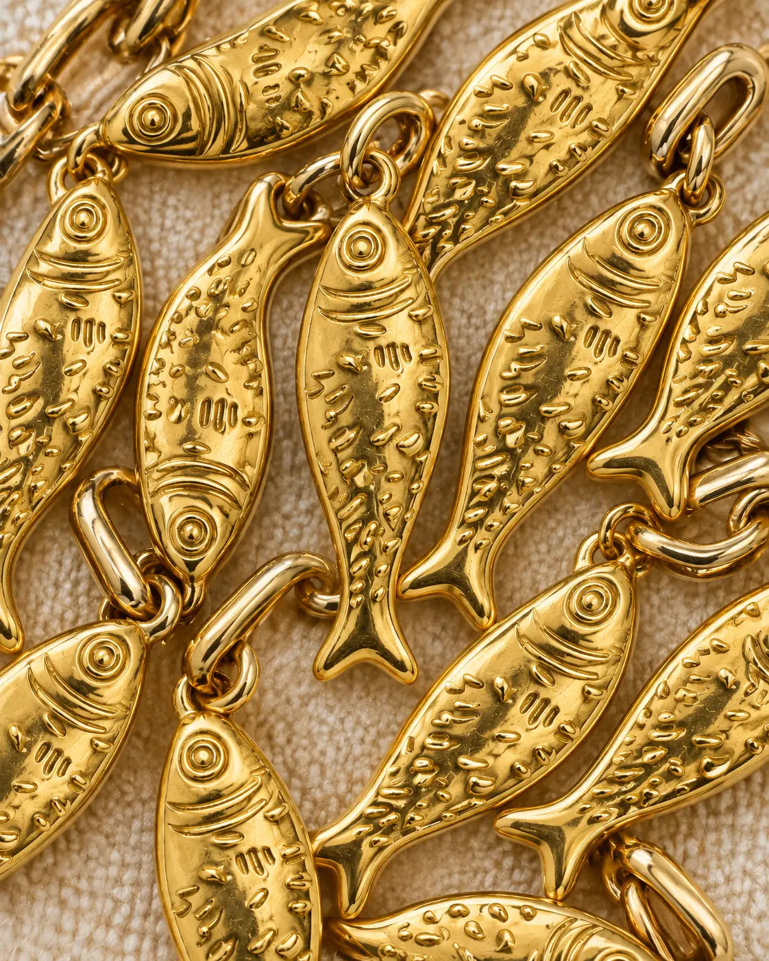 Lucky Fish Charm – pile of gold fish charms showing texture