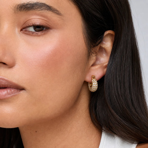 Lumi Pavé Huggies worn on the ear, close-up – anti-tarnish huggie earrings for daily wear