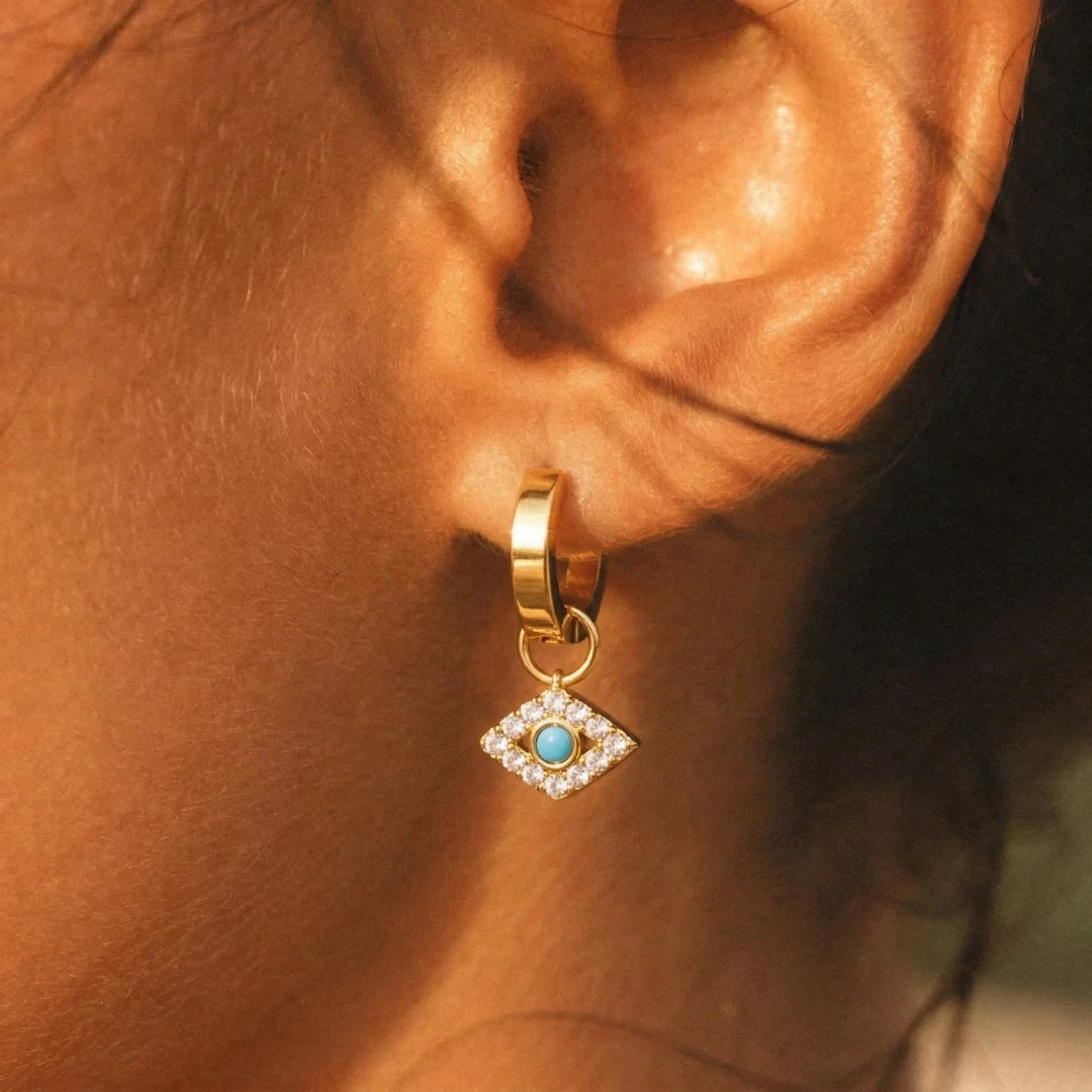 Nazar Charm Hoops worn on the ear, close-up on the evil eye charm – anti-tarnish evil eye earrings for daily wear