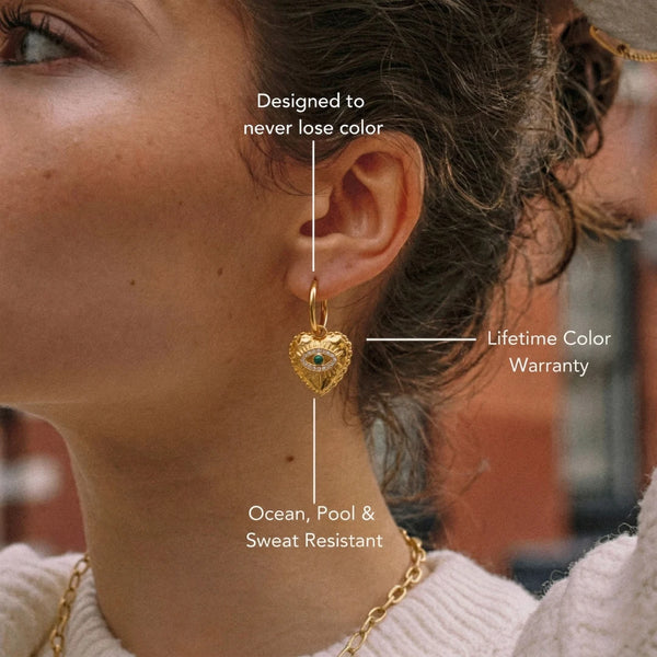 Nazar Heart Hoops worn on the ear with measurement labels – size and material details