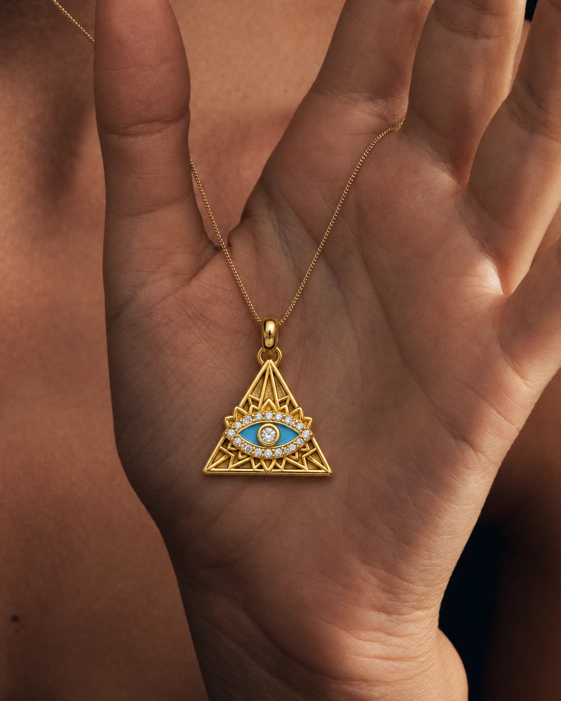 Nazar Pyramid Charm resting on an open palm to show scale – sweatproof, hypoallergenic charm