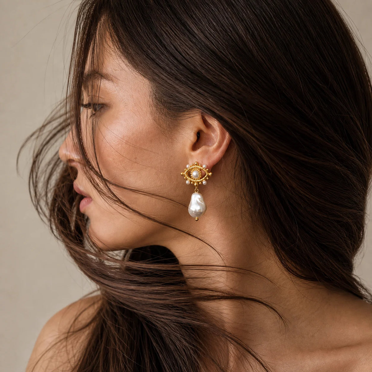 Pearl Nazar Drop Earrings worn by a model with long dark hair, waterproof gold drop earrings