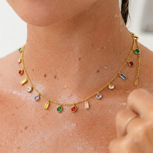 Rainbow Dainty Multi Charm Necklace worn on the neckline, close-up on the charms, 18K gold PVD