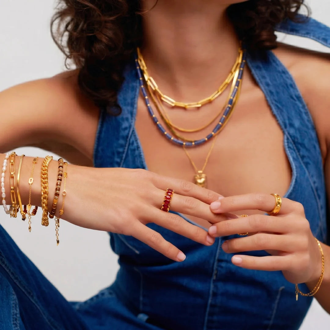 Ruby Crown Ring worn with gold bracelets and a blue halter top – sweatproof, hypoallergenic statement ring