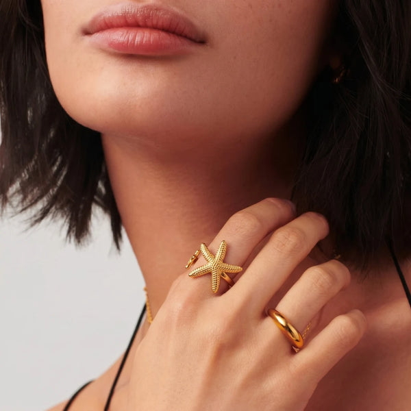 Starfish Ring worn on the finger by a model, hand at the face – anti-tarnish open ring for daily wear