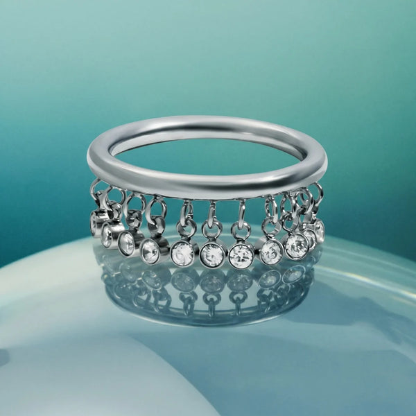 Starlight Dangle Ring silver version on a blue background, silver-tone stainless steel