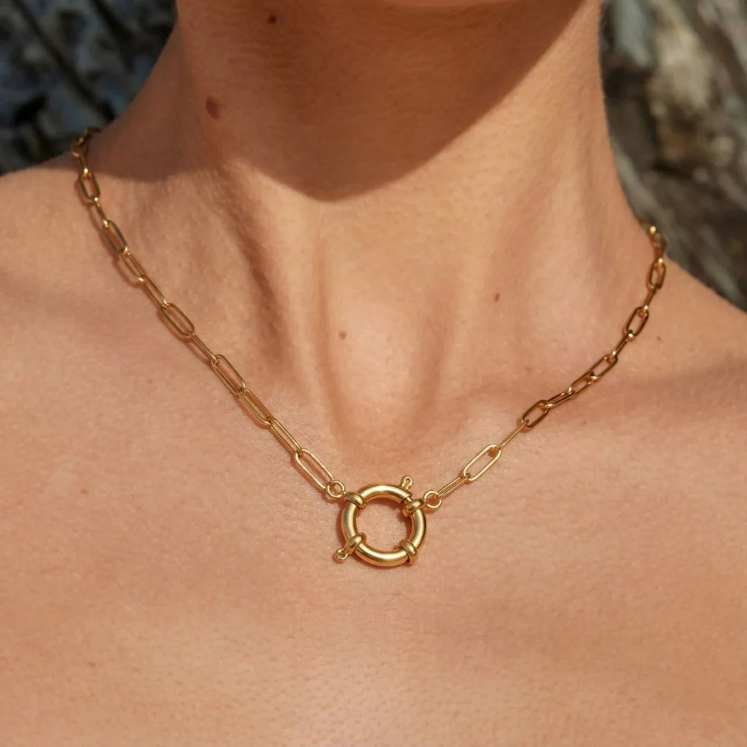 Toggle Link Necklace worn on the neckline with a green top, 18K gold PVD