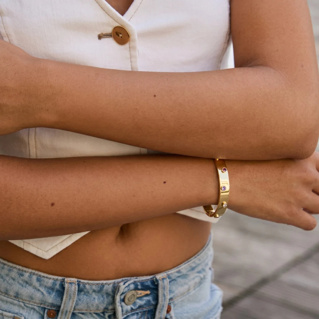 Wide Crystal Bangle worn on the wrist with a white crop top and jeans, 18K gold PVD